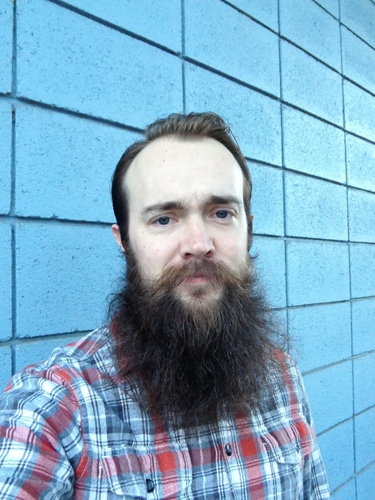 A portrait of Skye Larsen and his large beard.